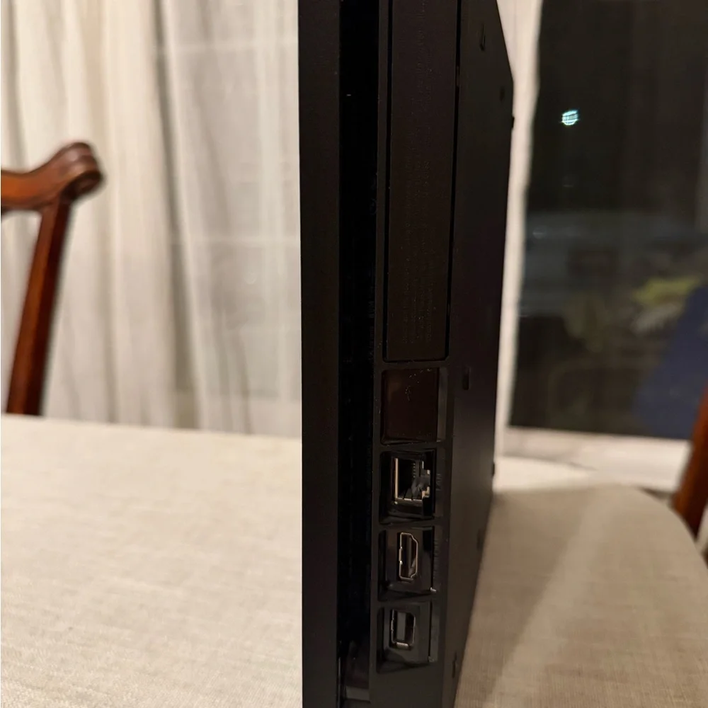 Sony PlayStation 4 (PS4) with controllers